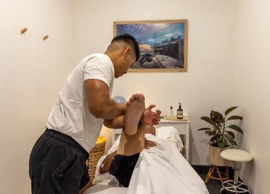 Massage therapist performing leg stretch at Kazspace in Sydney, Potts Point, New South Wales, AU.