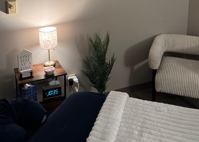 Comfortable massage room at M & M Massage in Norfolk, Nebraska, US, featuring a cozy chair and ambient lighting.