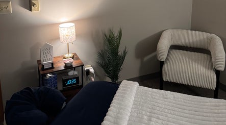 Comfortable massage room at M & M Massage in Norfolk, Nebraska, US, featuring a cozy chair and ambient lighting.