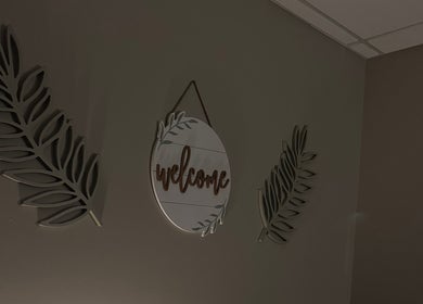 Welcome sign with leaf decor in M & M Massage, Norfolk, Nebraska, US.