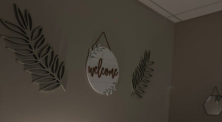 Welcome sign with leaf decor in M & M Massage, Norfolk, Nebraska, US.