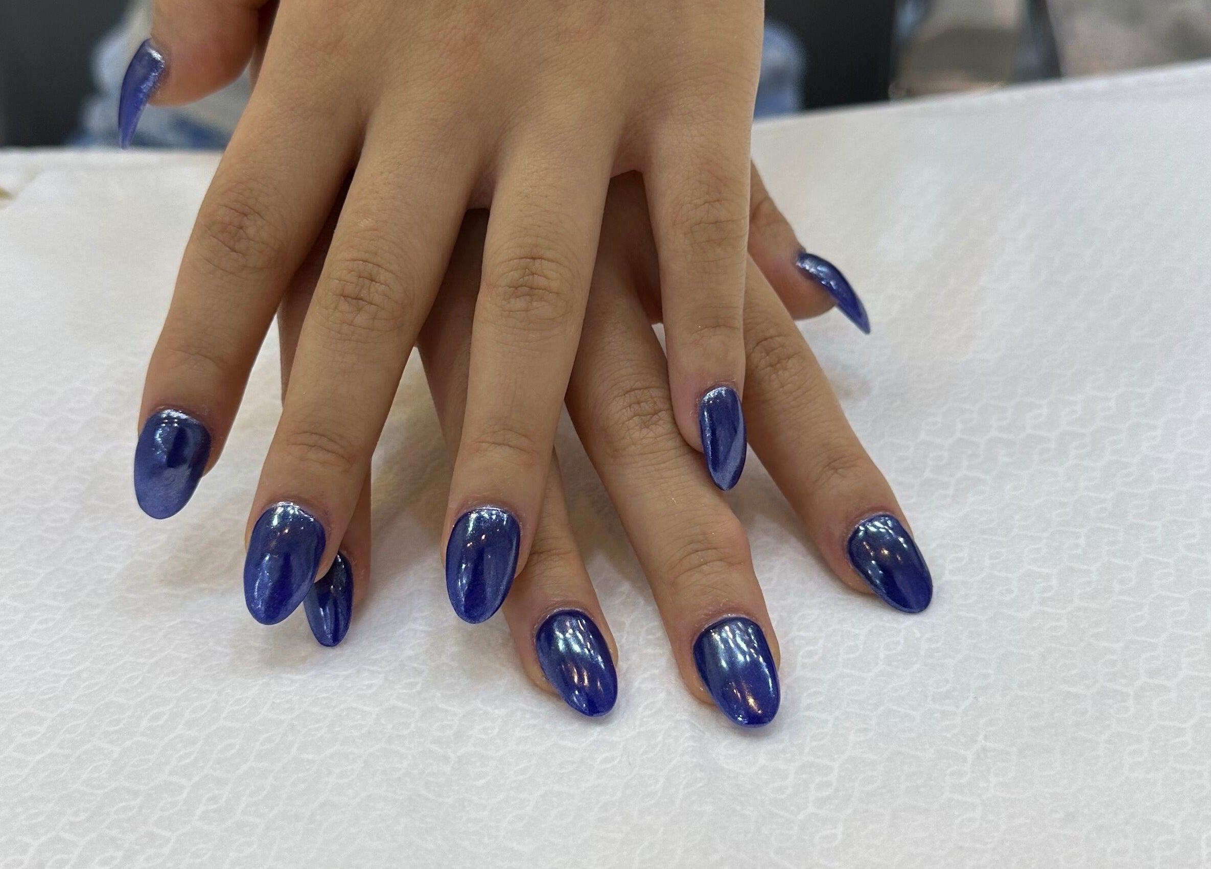 Beautiful blue manicure at Beauty Creation Home Service, Dubai, Dubai, AE, showcasing elegant nail art.