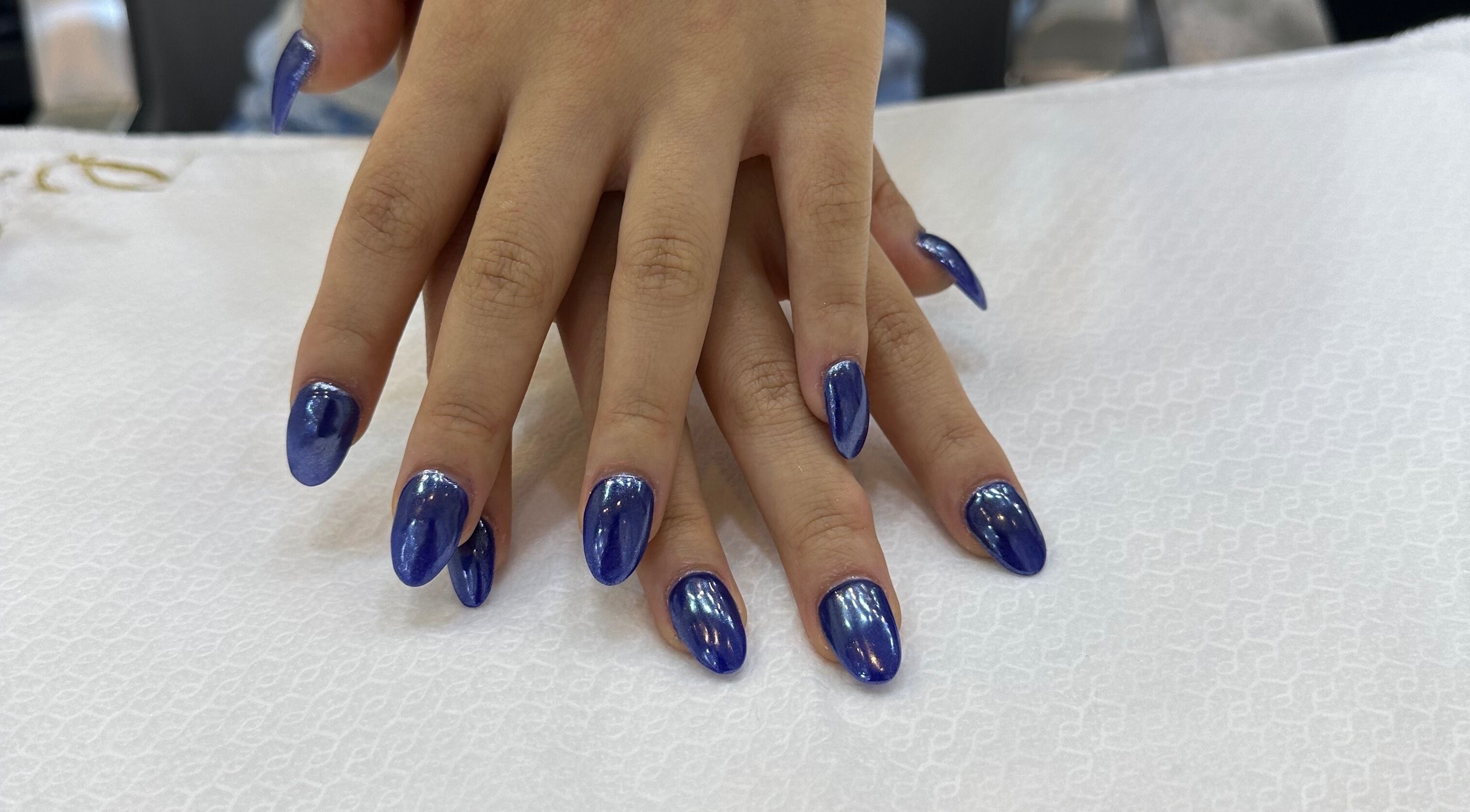 Beautiful blue manicure at Beauty Creation Home Service, Dubai, Dubai, AE, showcasing elegant nail art.