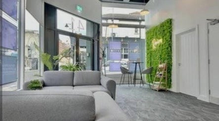 Bright seating area at Katie Betty Laser & Aesthetics, Portsmouth, England, GB featuring modern design and greenery.