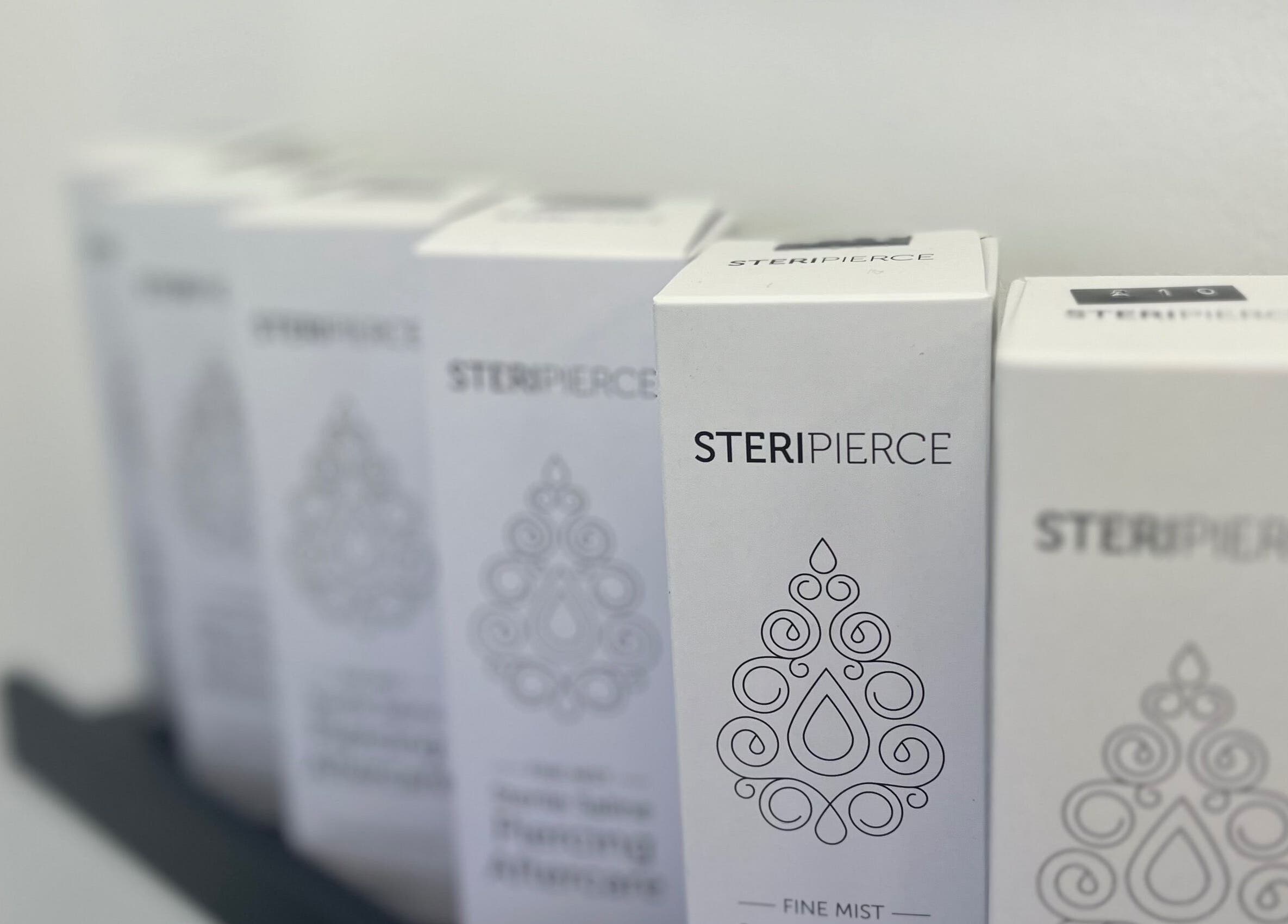 Steripierce product boxes on shelf at Bobbi's Aesthetics & Piercing, Bletchley, England, GB.