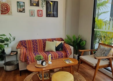 Inviting lounge area at Justwax PIK in Daerah Khusus Ibukota Jakarta, featuring stylish decor and greenery.