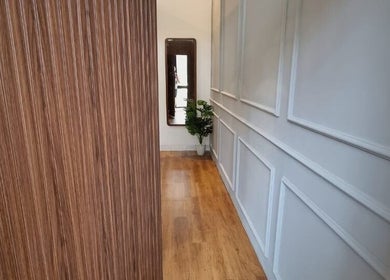 Elegant hallway at Justwax PIK in Daerah Khusus Ibukota Jakarta, featuring wood flooring and modern decor.