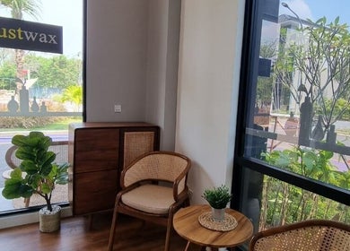 Cozy seating area at Justwax PIK with leafy plants in Daerah Khusus Ibukota Jakarta, Daerah Khusus Ibukota Jakarta, ID.