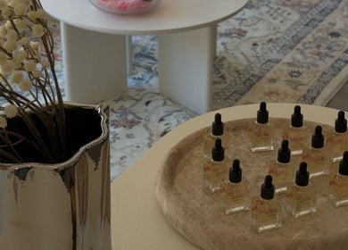 Display of oils and decor at Doll Nails, Bexley, New South Wales, AU, showcasing elegant wellness ambiance.