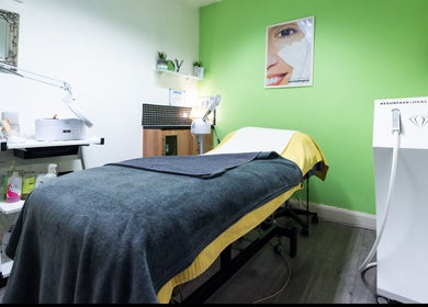 A tranquil treatment room at Beauty Plus, London, England, GB with a treatment bed and modern equipment.