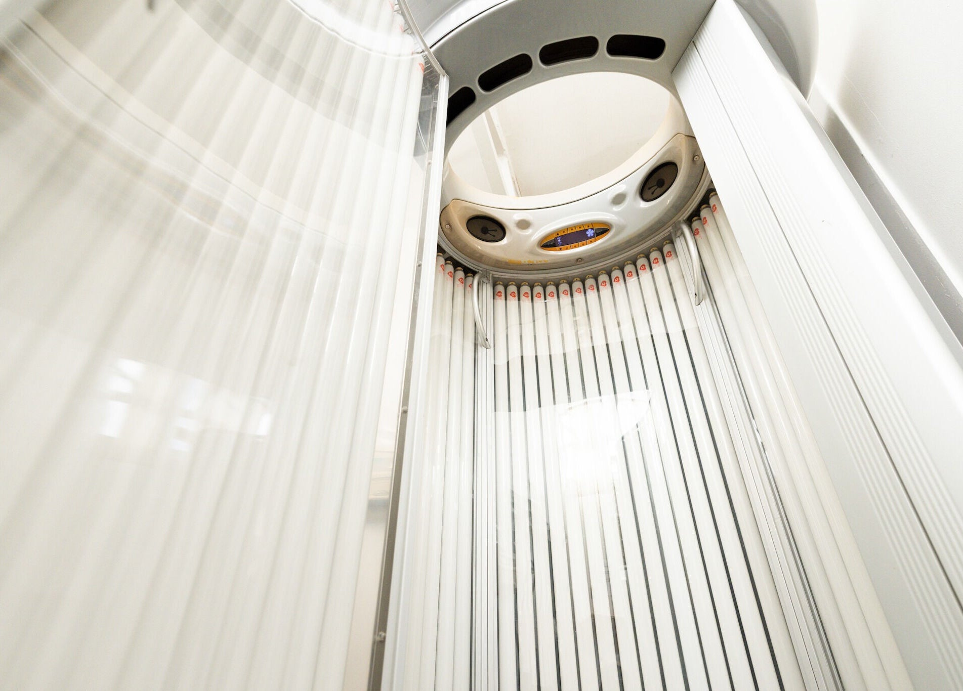 Vertical tanning booth at Beauty Plus, London, England, GB offers a sleek sun-kissed glow experience.