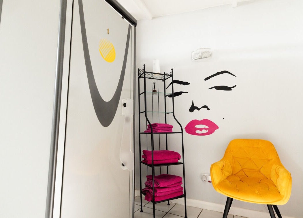 Modern beauty room at Beauty Plus, London, England, GB with bright decor and stylish yellow chair.