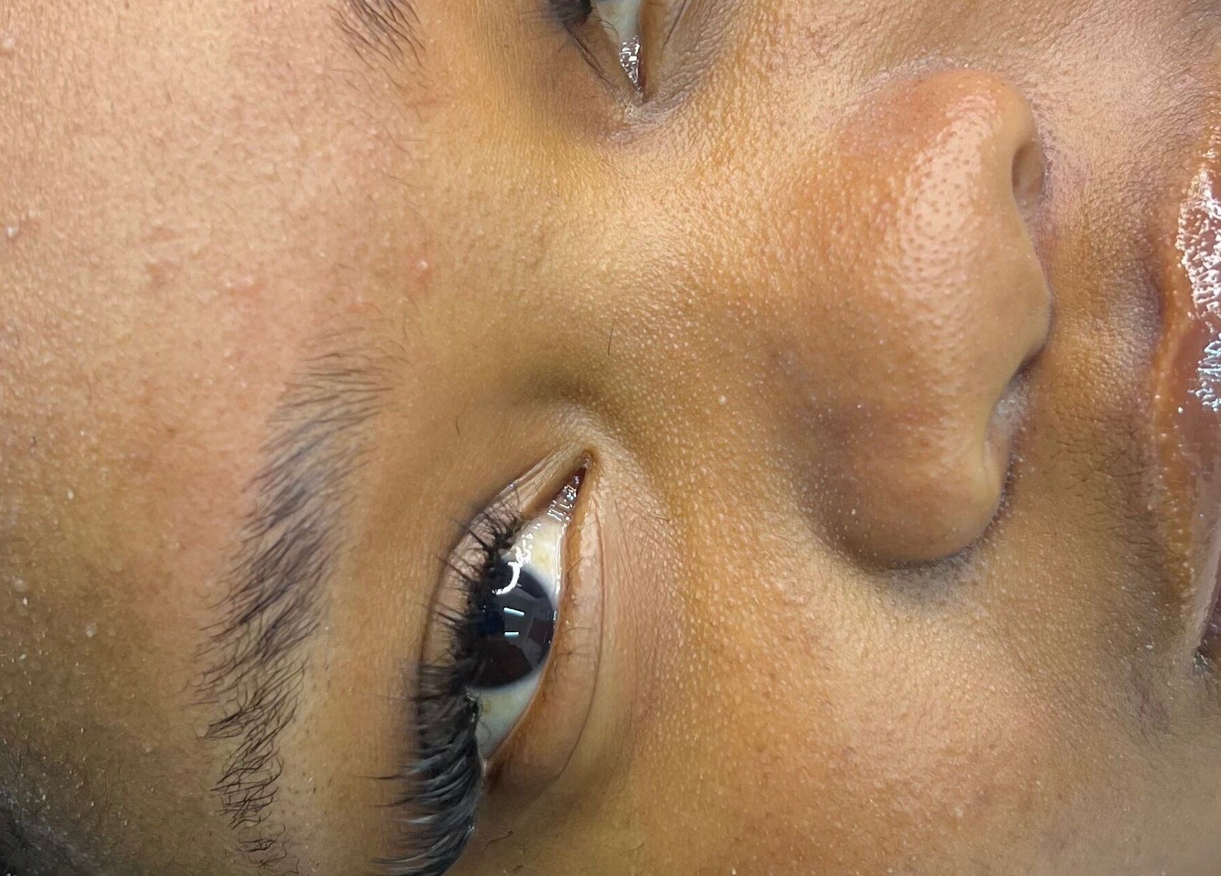 Close-up of a client's face showing glowing skin at Belle B Luxe studio, Roodepoort, Gauteng, ZA.
