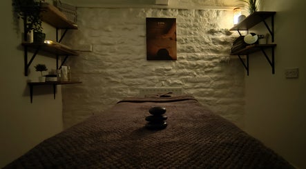 Tranquil spa treatment room at Mirror Mirror Bingley, Bingley, England, GB with massage table and warm lighting.