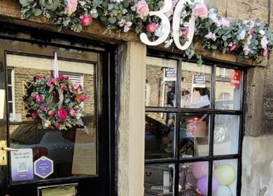 The charming entrance of Mirror Mirror Bingley adorned with floral decorations in Bingley, England, GB.