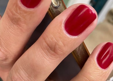 Close-up of vibrant red manicure at Powder Beauty At Duke House, Brighton, England, GB.