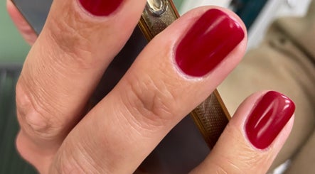 Close-up of vibrant red manicure at Powder Beauty At Duke House, Brighton, England, GB.
