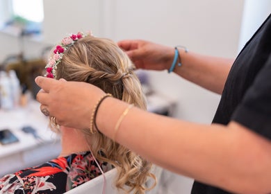 Hairstylist crafting floral hairstyle at Powder Beauty At Duke House, Brighton, England, GB.