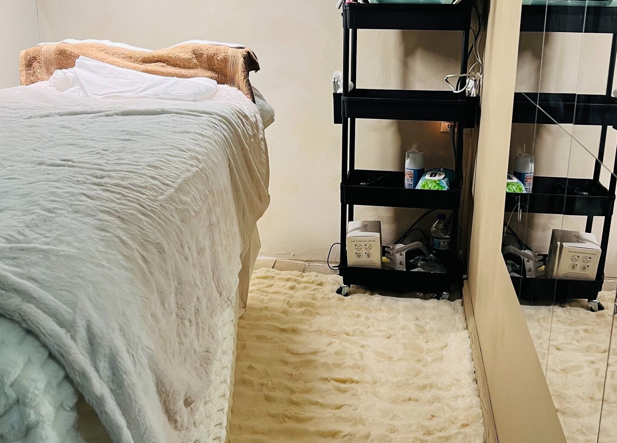 Relaxing treatment room at Blxc Gold Aesthetics, Kingston, St. Andrew Parish, JM with a soft bed and essentials.