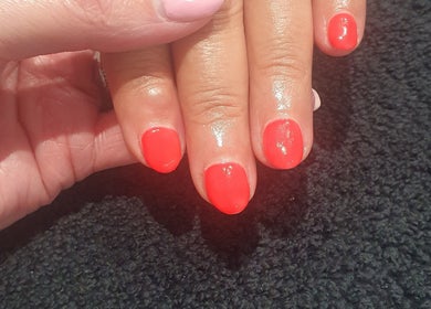 Bright red manicure at Bare Faced Beauty by Charlie, Helsby, England, GB, showcasing expert nail care.