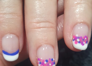 Vibrant nail art with dots and stripes at Bare Faced Beauty by Charlie, Helsby, England, GB.