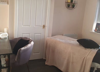 Cozy treatment room at BareFaced Beauty by Charlie in Helsby, England, GB offering a relaxing spa experience.