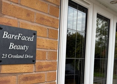 Entrance sign of BareFaced Beauty by Charlie, a beauty venue in Helsby, England, GB.