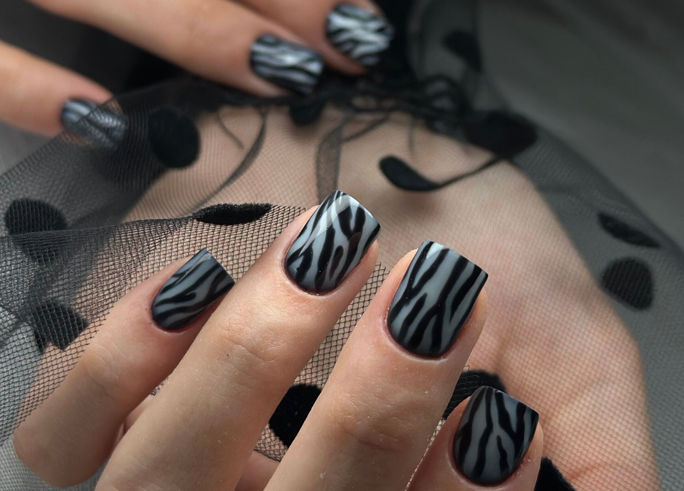 Chic zebra nail art at ManiCraft Nails, Cork, County Cork, IE. Sleek and stylish designs on manicured hands.