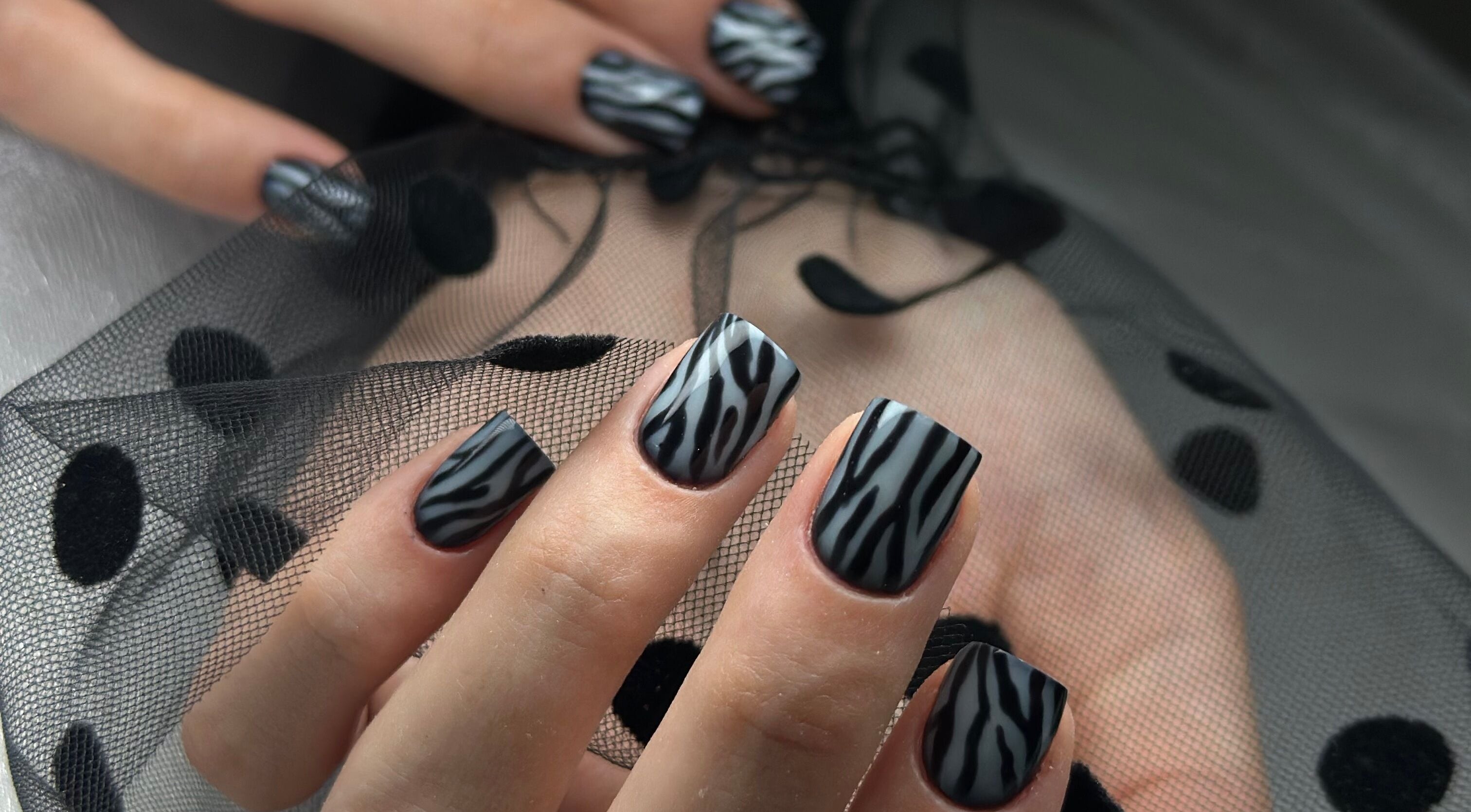 Chic zebra nail art at ManiCraft Nails, Cork, County Cork, IE. Sleek and stylish designs on manicured hands.
