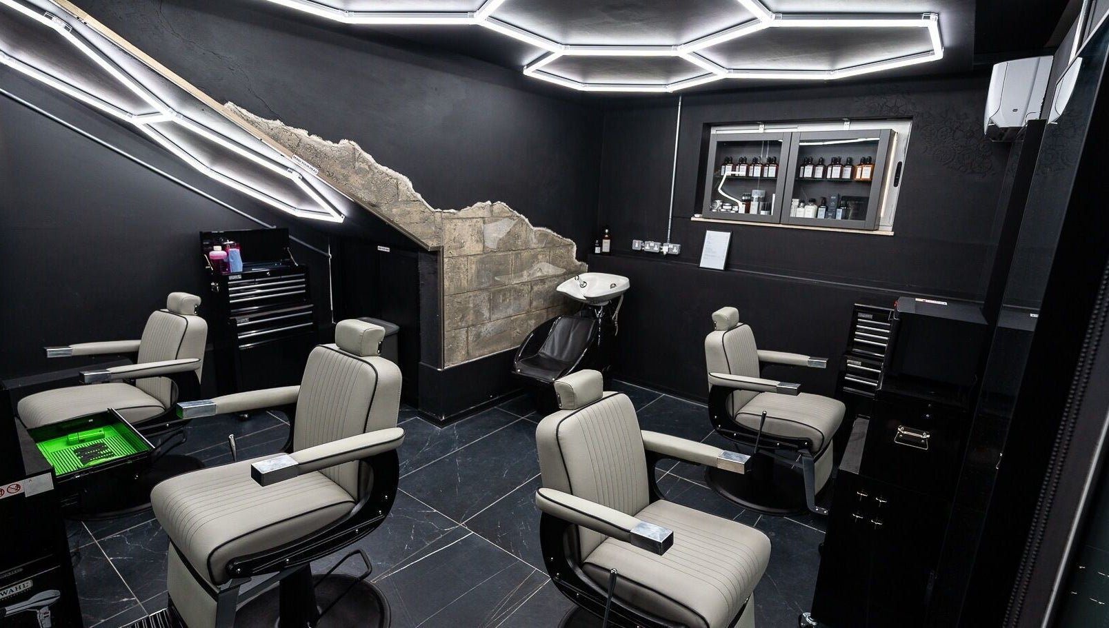 Modern barber interior at Mr. Dapper Barbers & Tattoo, L-Imsida, MT, featuring sleek chairs and styling tools.