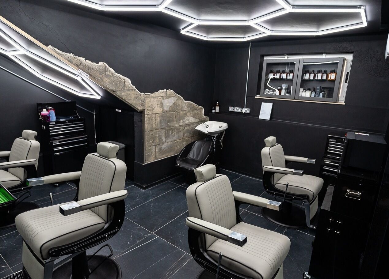 Modern barber interior at Mr. Dapper Barbers & Tattoo, L-Imsida, MT, featuring sleek chairs and styling tools.