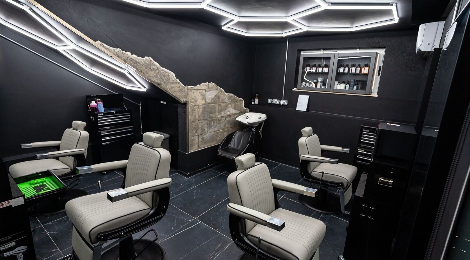 Modern barber interior at Mr. Dapper Barbers & Tattoo, L-Imsida, MT, featuring sleek chairs and styling tools.