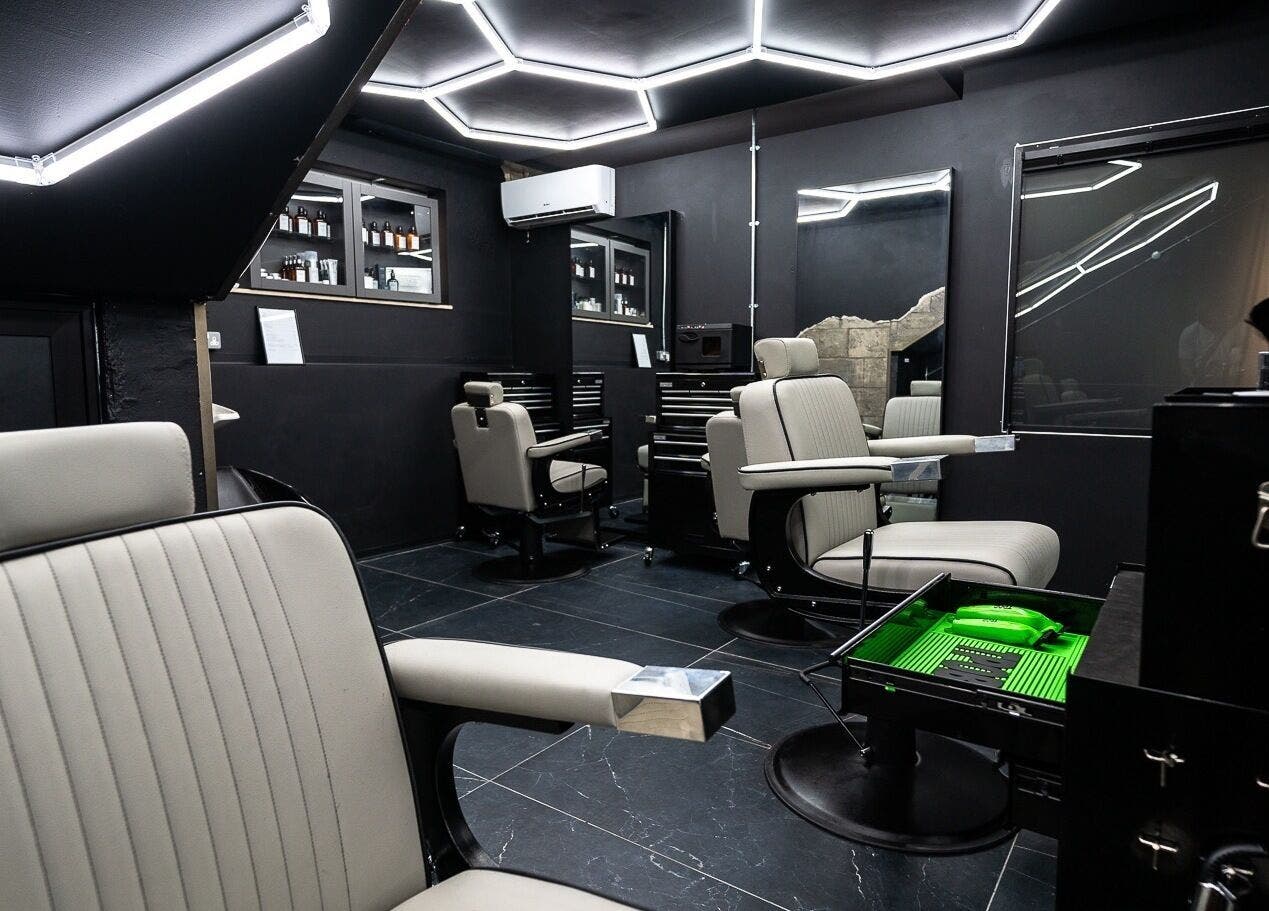 Elegant interior of Mr. Dapper Barbers & Tattoo in L-imsida, MT, featuring modern barber chairs and sleek decor.