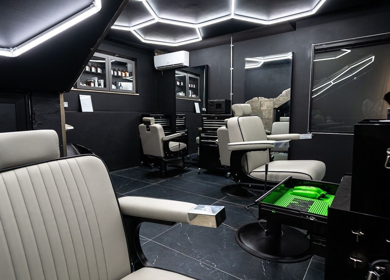 Elegant interior of Mr. Dapper Barbers & Tattoo in L-imsida, MT, featuring modern barber chairs and sleek decor.