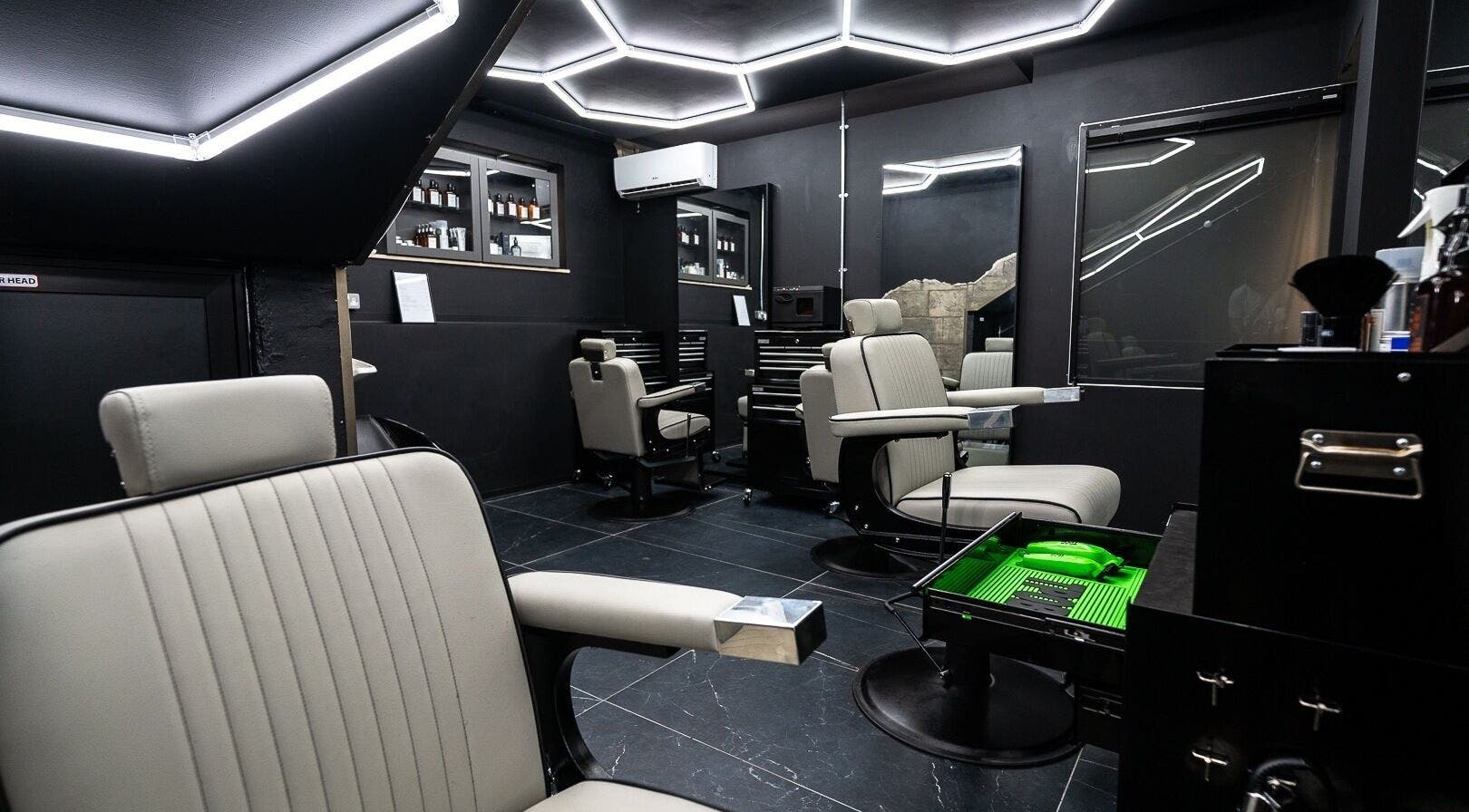 Elegant interior of Mr. Dapper Barbers & Tattoo in L-imsida, MT, featuring modern barber chairs and sleek decor.