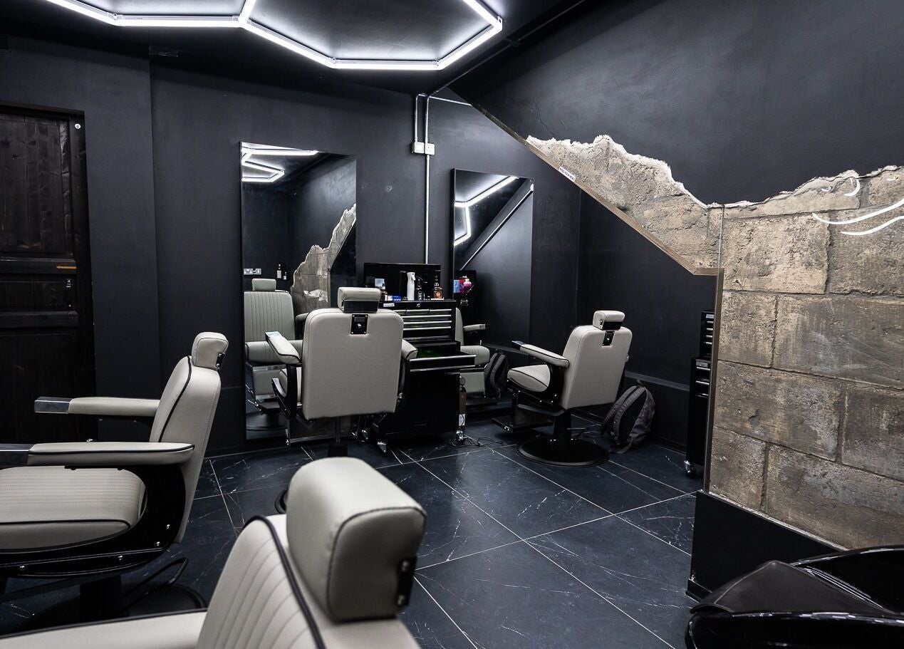 Stylish interior of Mr. Dapper Barbers & Tattoo in L-imsida, MT, showcasing sleek, modern grooming chairs.