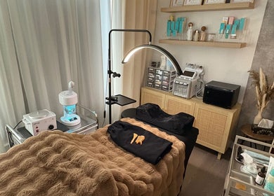 Cozy treatment room at S.Leigh Studio, Edmonton, Alberta, CA, featuring a massage table and skincare products.