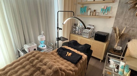 Cozy treatment room at S.Leigh Studio, Edmonton, Alberta, CA, featuring a massage table and skincare products.