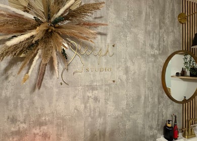 Elegant wall decor at S.Leigh Studio, Edmonton, Alberta, CA showcasing a mirror and pampas grass.