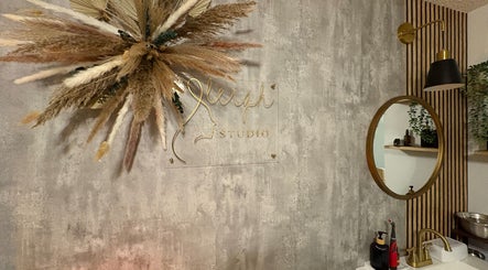 Elegant wall decor at S.Leigh Studio, Edmonton, Alberta, CA showcasing a mirror and pampas grass.