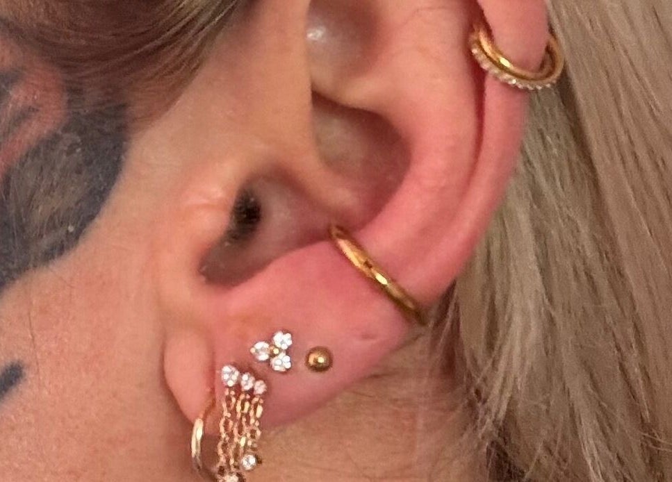 Stylish ear piercings with gold hoops at Pretty Piercings by Sheree in Crosshill, Scotland, GB.