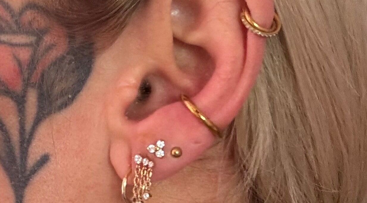 Stylish ear piercings with gold hoops at Pretty Piercings by Sheree in Crosshill, Scotland, GB.