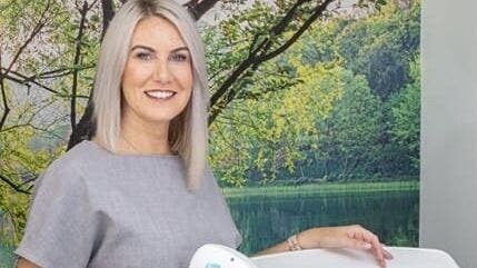 Professional specialist smiling at AKBrows - Richmond, set against a calming nature backdrop. Richmond, England, GB.