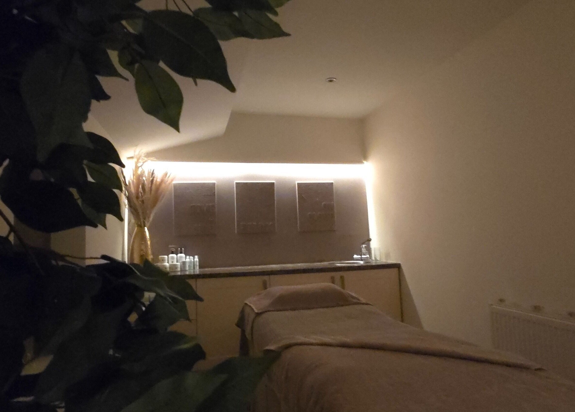 Tranquil therapy room at AK Laser Beauty & Brows, Accrington, England, GB, with a massage table and calming decor.