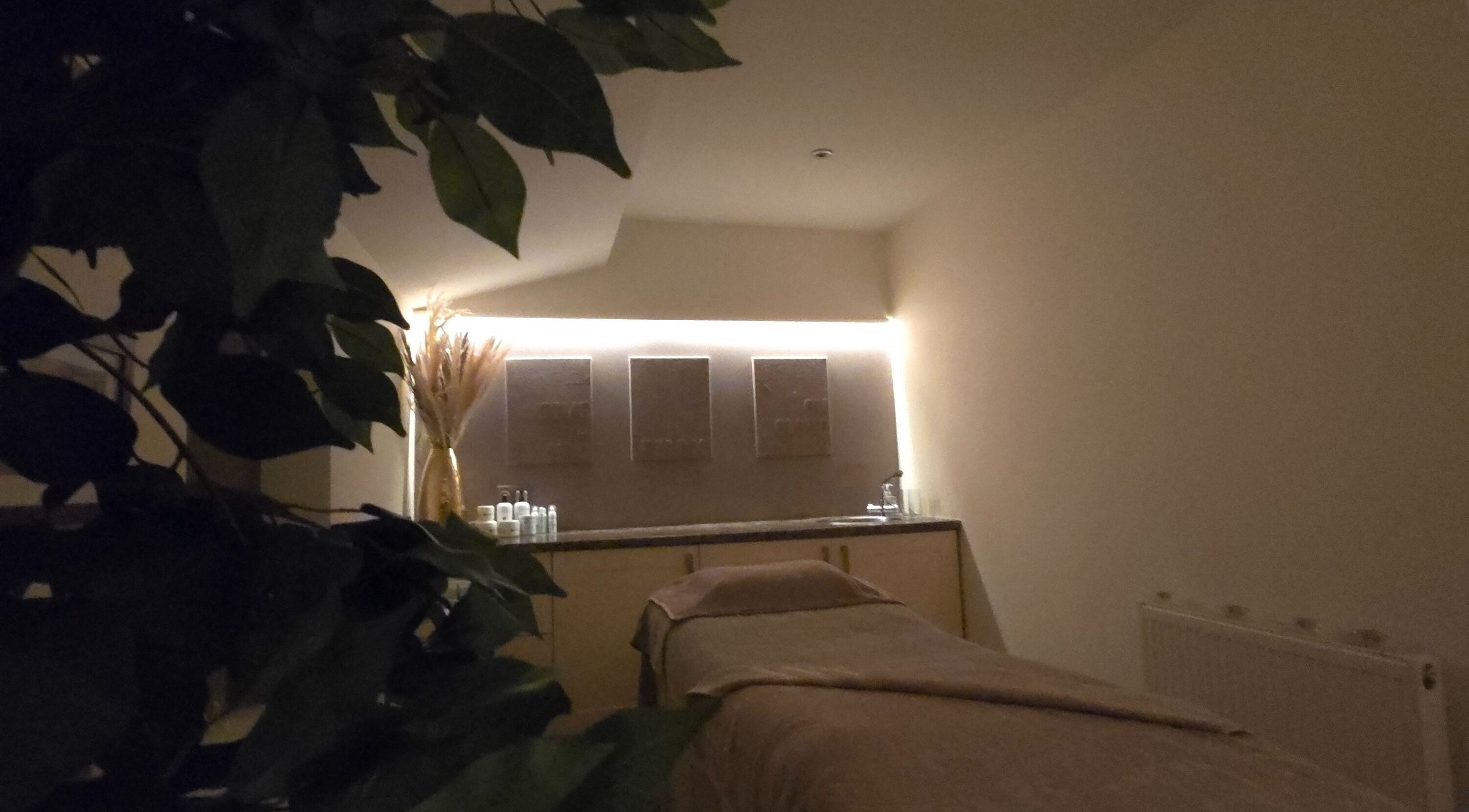 Tranquil therapy room at AK Laser Beauty & Brows, Accrington, England, GB, with a massage table and calming decor.