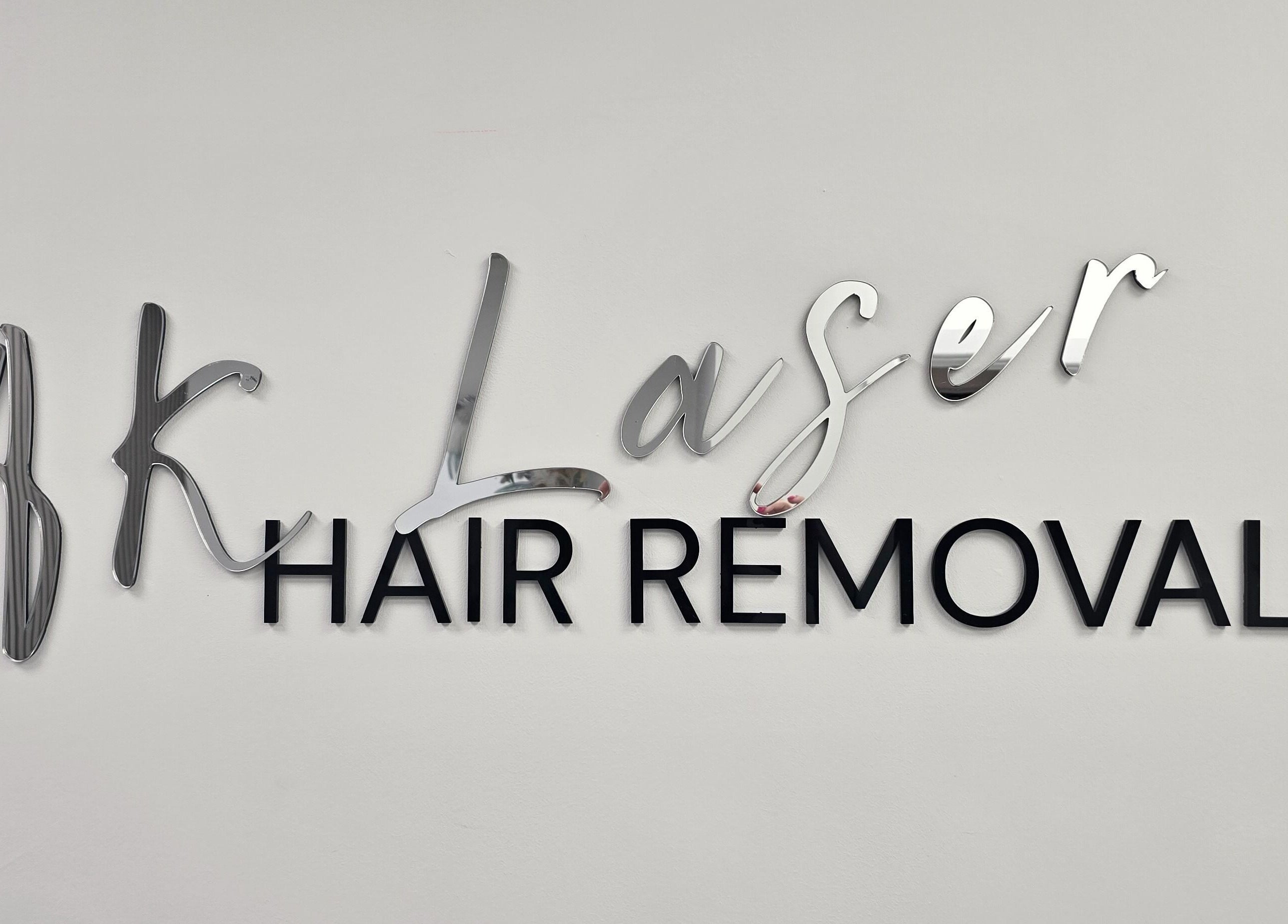 AK Laser Beauty & Brows logo for hair removal in Accrington, England, GB in elegant metallic finish.