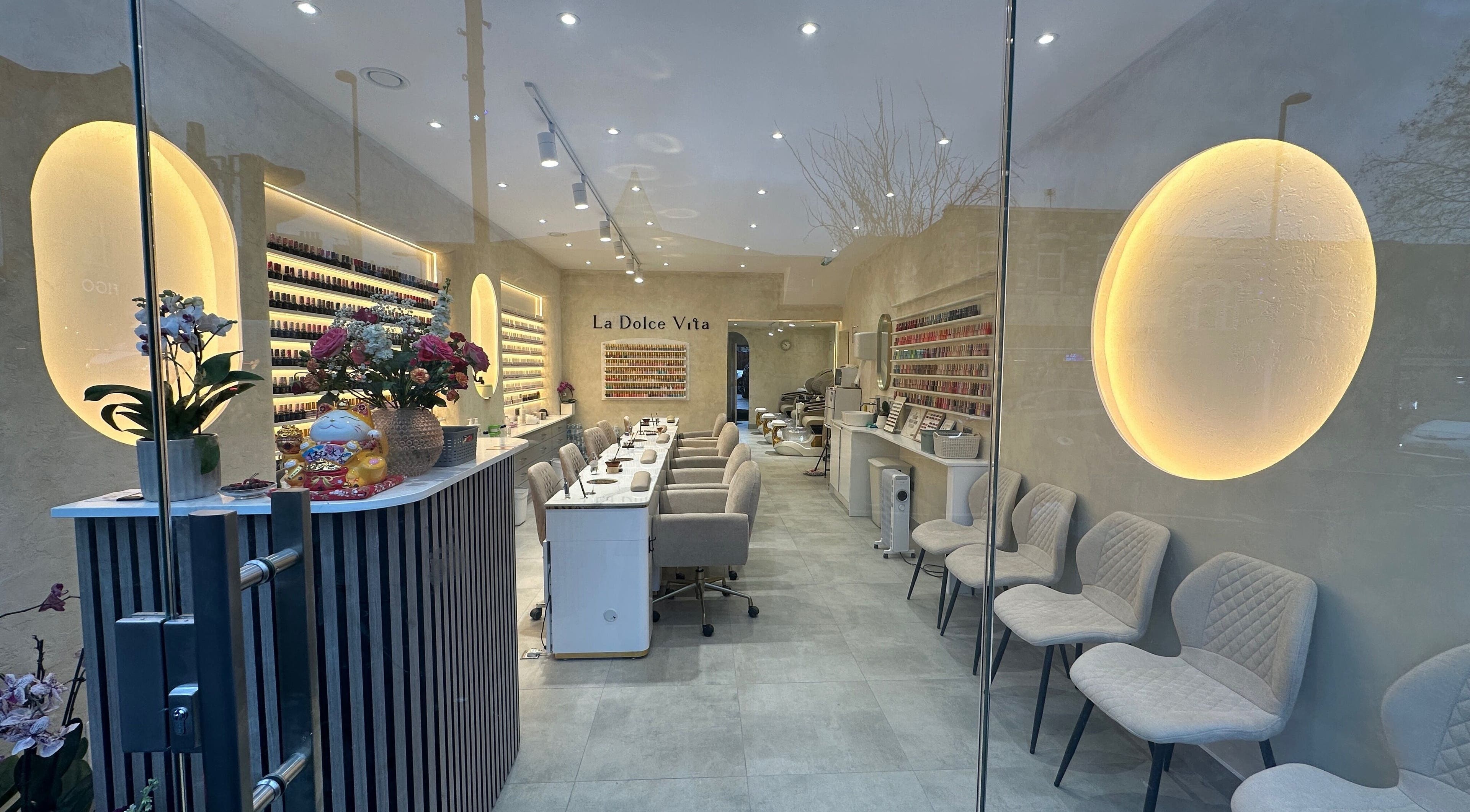 Interior of CN Nails Studio in London, England, GB, showcasing chic seating and nail polish displays.