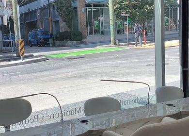 View from Champagne Nail Lounge on Drake, Vancouver, BC showcasing street scene and modern interior.