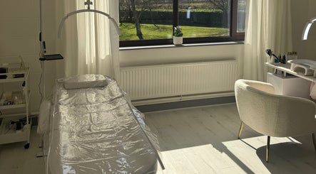 Bright treatment room at All Things Beauty in Flitwick, England, GB with modern equipment and outdoor views.