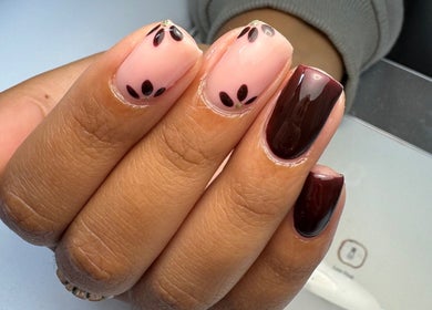 Elegant nail art at All Things Beauty, Flitwick, England, GB. Features glossy maroon and pink designs.
